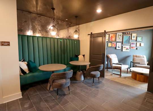 a dining room with a green booth and tables and chairs
