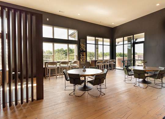 a large dining room with tables and chairs and windows