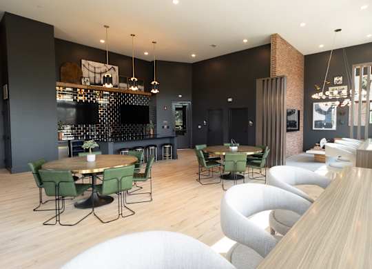 a dining room with tables and chairs and a bar