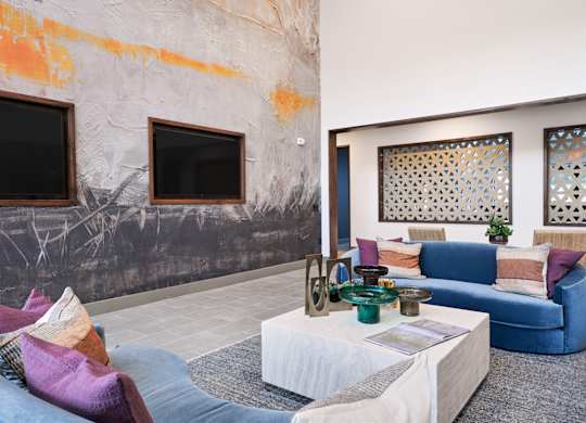 A living room with a grey couch and a white coffee table.
