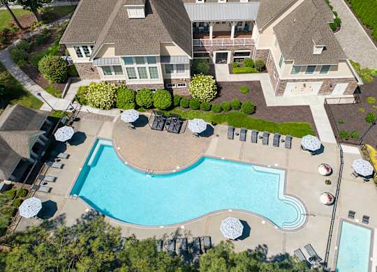 An aerial view of a house with a swimming pool.