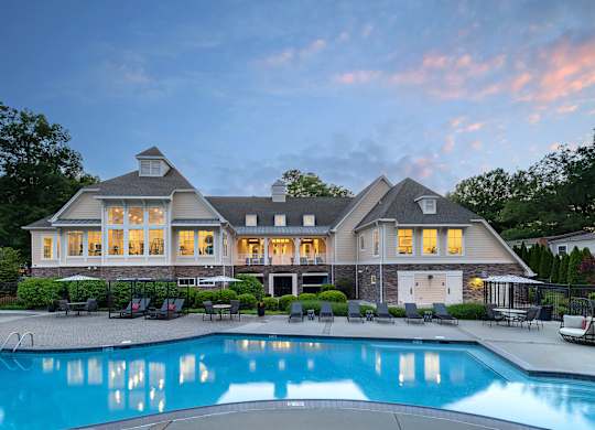 A large house with a pool in front.