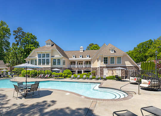 A large house with a pool in front.