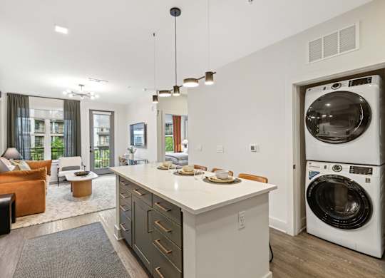 A modern kitchen with a washing machine in the door.