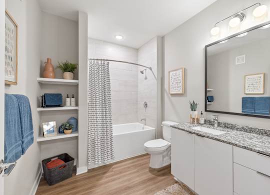 A bathroom with a white toilet, a white sink, and a white bathtub.