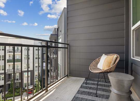 A balcony with a chair and a table.