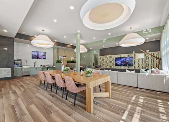 A modern dining room with a wooden table and chairs.
