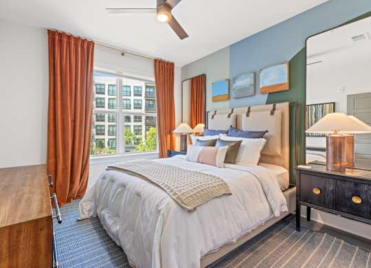 A bedroom with a large bed and a wooden headboard.