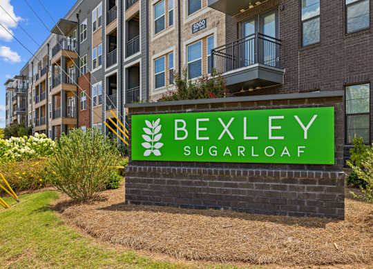 A sign for Bexley Sugarloaf in front of a building.