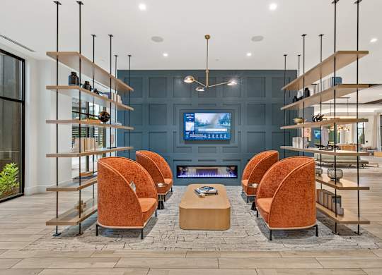 A modern living room with a fireplace and a television.