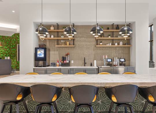 A modern kitchen with a long table and chairs.