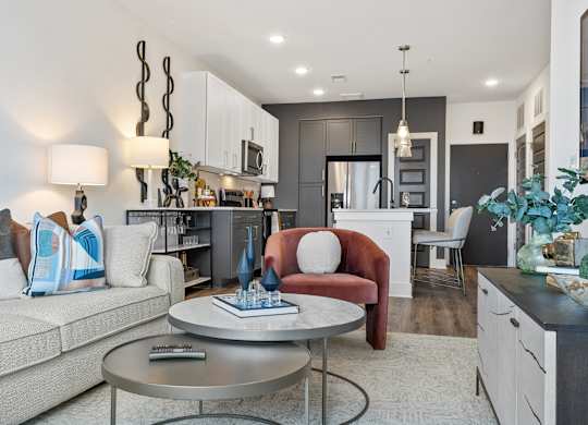 A modern living room with a red armchair and a grey coffee table.