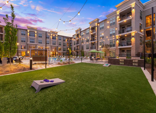 a backyard with a trampoline and a hot tub