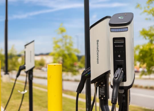 a row of electric car chargers in a park