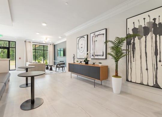 a living room filled with furniture and a large window