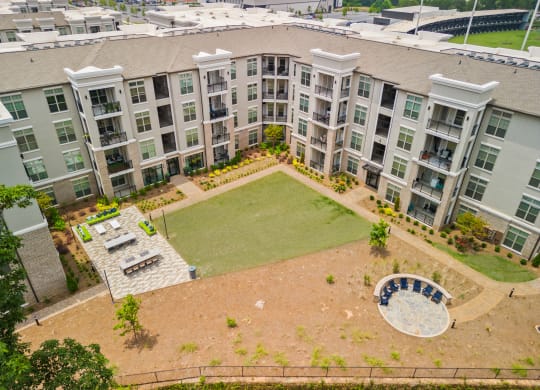 an aerial view of an apartment complex with a large lawn