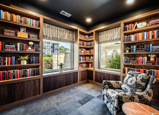 A room with a black ceiling and a chair with a floral pattern on it.
