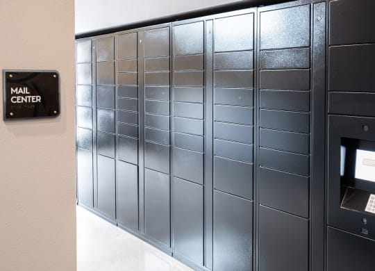 A row of mailboxes are lined up next to a wall.