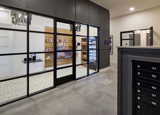 A modern kitchen with a glass door refrigerator and a tiled floor.