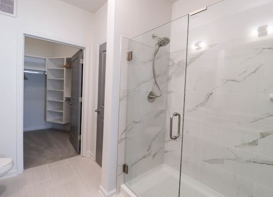 a bathroom with a shower and a closet