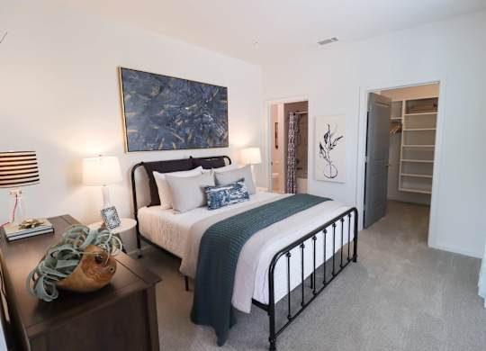 a bedroom with a bed and a painting on the wall