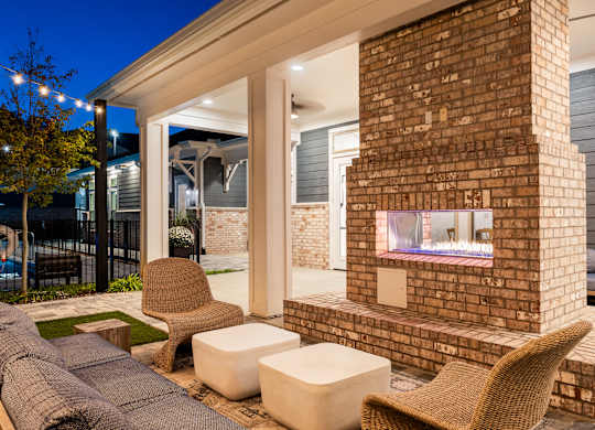 A patio with a fireplace and seating area.