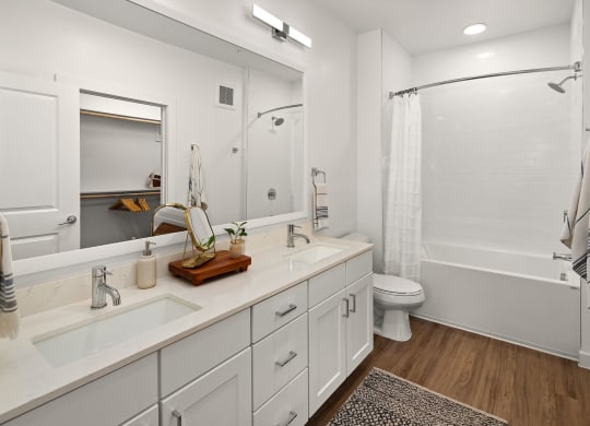a bathroom with white cabinets and a shower and a toilet