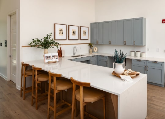 a kitchen with a white counter top and blue cabinets