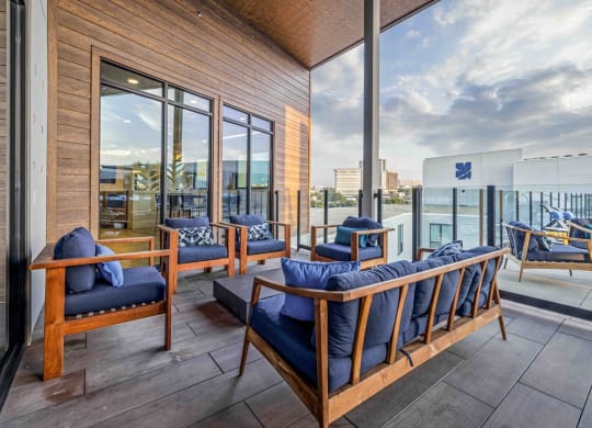 a living room with a balcony and a view of the city