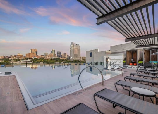 a swimming pool with a city skyline in the background