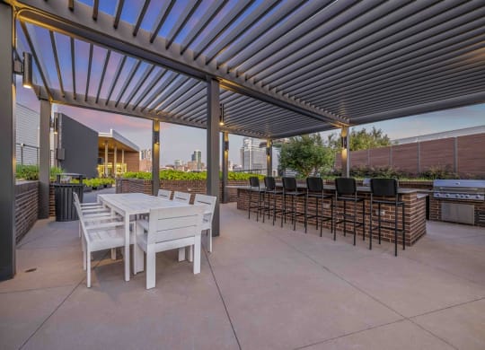 a patio with tables and chairs under awning