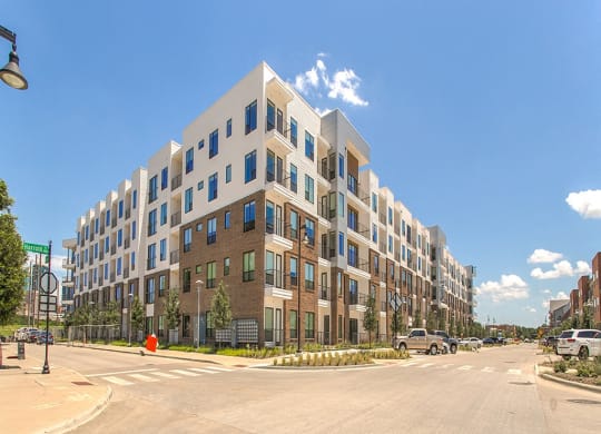a large apartment building on the corner of a city street