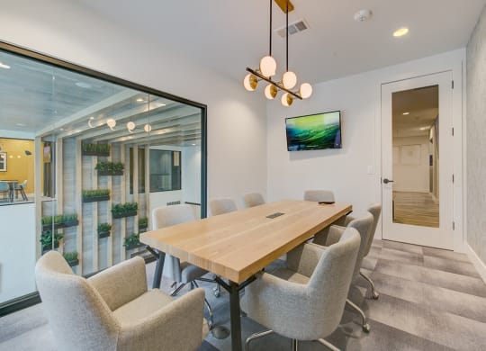 a dining room with a wooden table and chairs