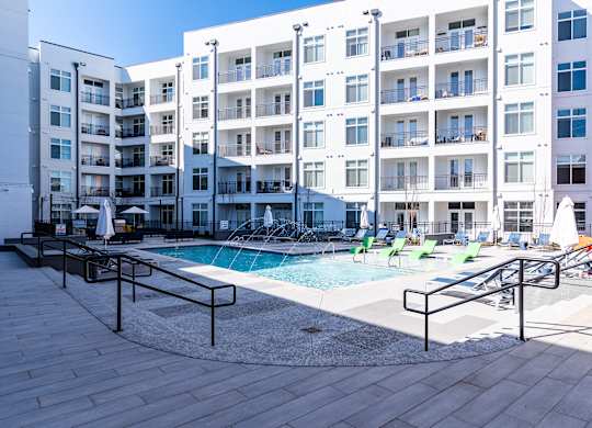 a swimming pool in front of an apartment building