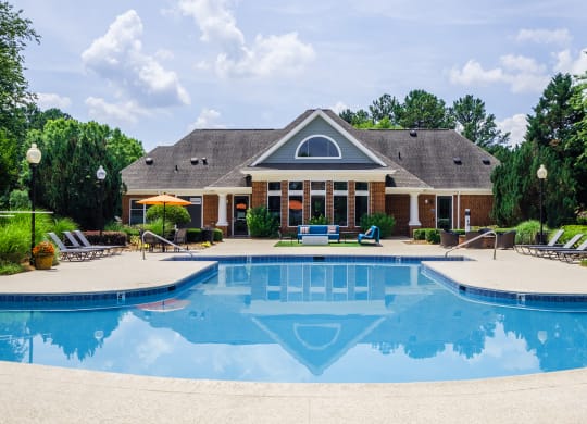 a swimming pool with a house in the background