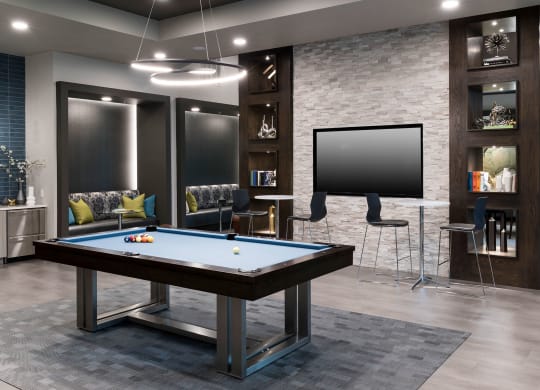 a game room with a pool table and a tv