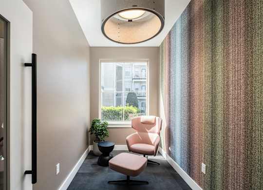 A hallway with a chair and a plant.