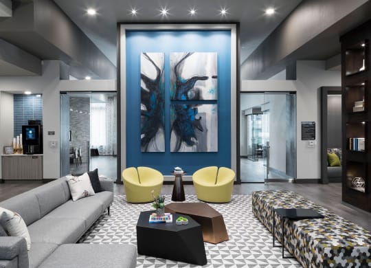 a living room with a blue wall and a couch and tables