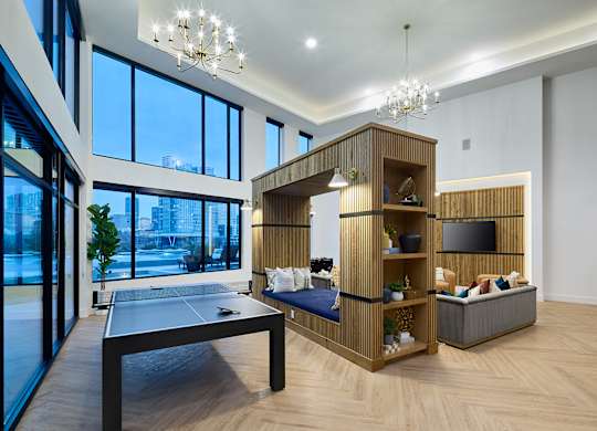A modern living room with a pool table and a television.