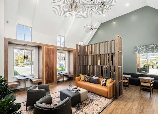 A living room with a large couch and a wooden partition.