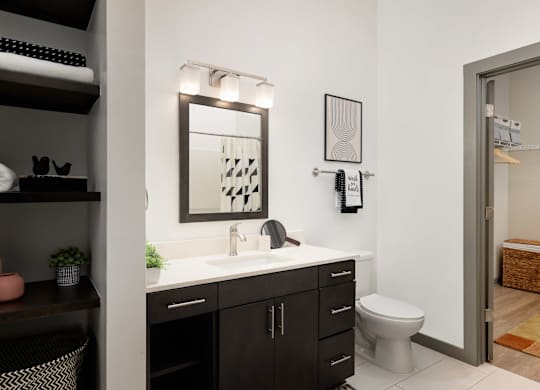 A bathroom with a white sink and a mirror above it.