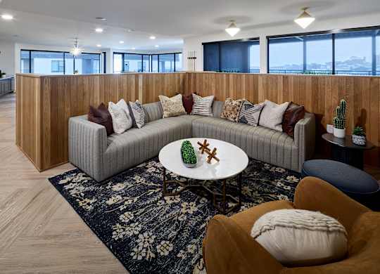 A modern living room with a grey sofa and a round table.