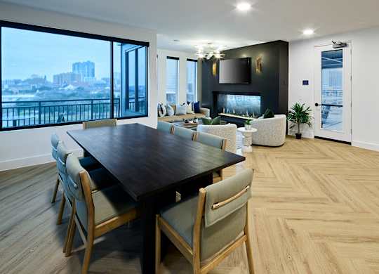 A modern dining room with a large table and chairs.