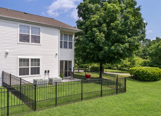 a large white house with a black fence in front of it