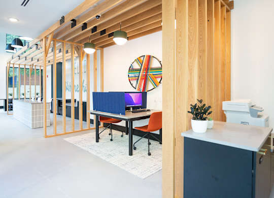 a room with a desk and a computer in it