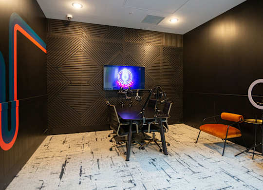 a room with a desk with a computer and a monitor