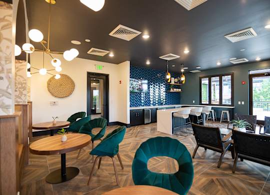 a dining room with tables and chairs and a bar