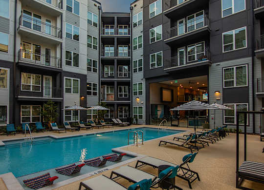 a swimming pool in front of an apartment building