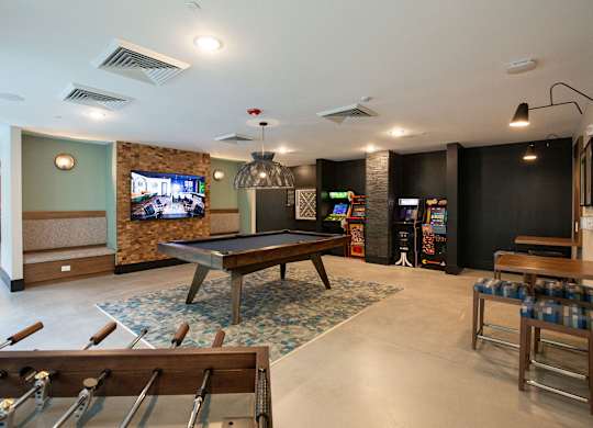 a game room with a pool table and a tv