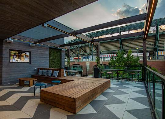 a communal area with a wooden bench and a glass roof